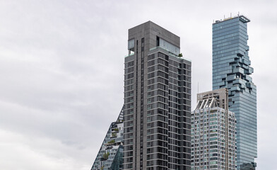 Obraz premium Bangkok, Thailand - 16 Jul 2023 - Architectural view of Skyscraper with Beautiful modern exterior buildings in Central Business district of Bangkok city. Copy space, Selective focus.