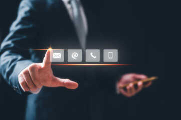 concept of Contact us or Customer support hotline people connect, businessman touching on virtual screen contact icons, email, address, live chat, phone. Customer service, help desk online support