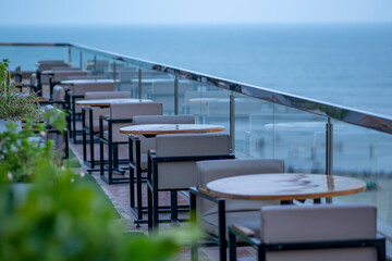 Fototapeta premium Cafe on the seaside. Beach holidays concept. Coffee shop outdoor Blurred. Picturesque cafe at the seashore