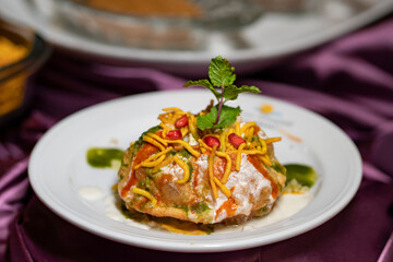 Rajasthani Shahi Raj-Kachori, stuffed with potato and sprout filling. served with curd, chutney and serve in a plate. Raj Kachori - popular Indian chaat which crispy fried shells