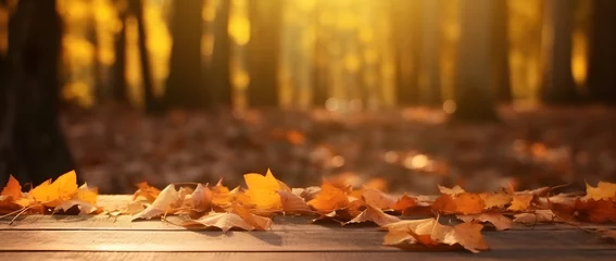Foto op Canvas  Autum background concept. Golden leaves fall onto a wooden table, with the background being a blurred bokeh autumn nature park. © Naige