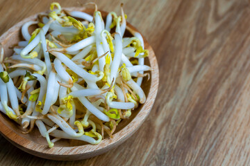 Beansprout in wooden bowl. Mungbean sprouts on wooden background.