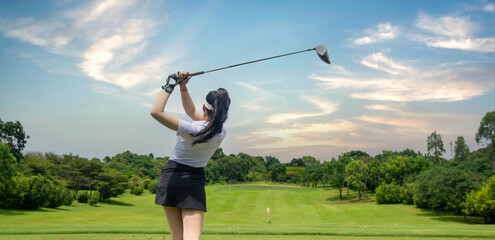 Professional woman golfer teeing to hole in player tournament competition at golf course for winner...