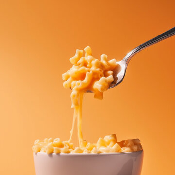 Food concept. A spoon of Macaroni Mac and Cheese baked cheesy with melting dripping cheese American classic staple, top view, close up