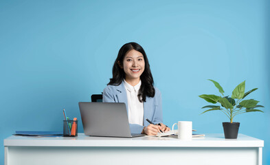image of asian businesswoman sitting and using laptop on desk