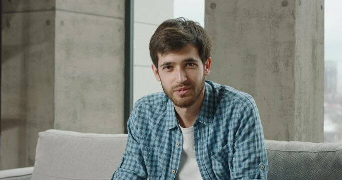 Video call with young Caucasian man. Smiling business man at home office listens nods head talks conducts remote interview with potential employee in company by video chat conference, web cam concept.