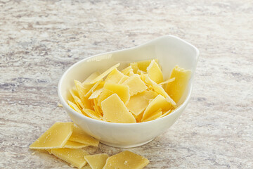 Sliced parmesan cheese heap in the bowl