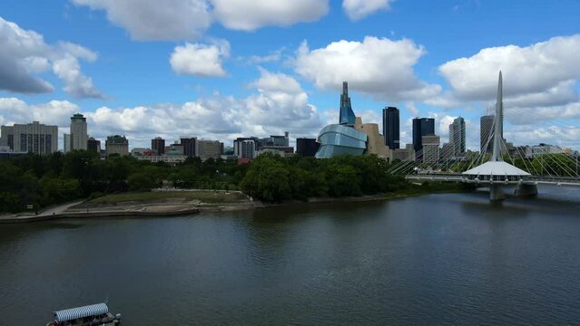 Aerial shot drone quickly ascends over the Red River in downtown Winnipeg, Canada