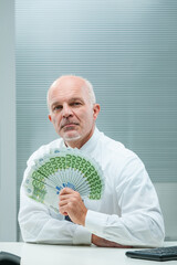 Elderly executive showcases European currency