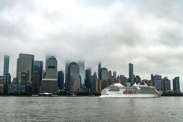 Cruise ship sailing next Manhattan in New York. Skyline of New York Manhattan cruising on the Hudson River cruise liner . Vacation on cruise liner.