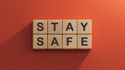 STAY SAFE - text on wooden cubes.3D rendering on red background.
