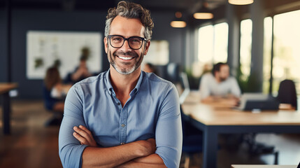 Fototapeta premium A Portrait of handsome smiling man sitting with arms crossed in office and looking at camera High quality photo with copy space.