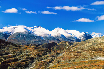 Mountain landscape with snow-capped mountain peaks in autumn