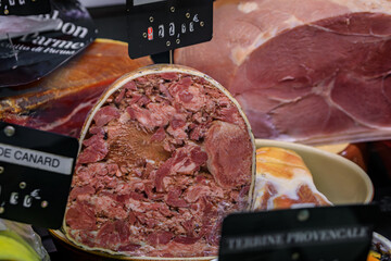 French butcher shop counter with head cheese for sale at a local farmers market in the Old Town Vieille Ville, Menton, French Riviera, South of France