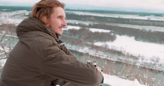 young man is happy as he has climbed on top of high mountain Slow motion Hicker gets pleasure from adventure Happiness Tender moments Guy adores wildlife, landscape, being in harmony with nature