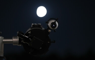 Observe the moon through an astronomy telescope. Astronomy as a hobby to explore the Universe.