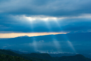 Naklejka na ściany i meble Heavenly Glows: Watch Crepuscular Rays amidst Transforming Clouds on the Peak. The Wufenshan Weather Radar Station stands on the top of the mountain. Taiwan