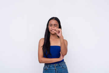 A young Filipino woman expressing something tiny with her fingers. Isolated on a white background.