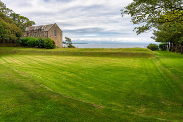 Obraz premium Beautiful green grass meadow off the east coast of Scotland, UK.