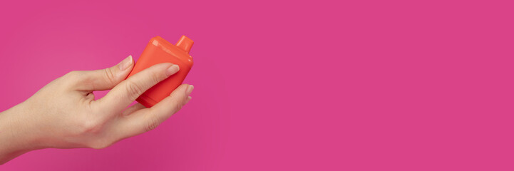 vape banner, disposable vape in smoker's hand on a pink background, copy space