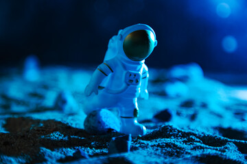 Astronaut in a spacesuit walks along the rocky surface of the planet. © lizavetta