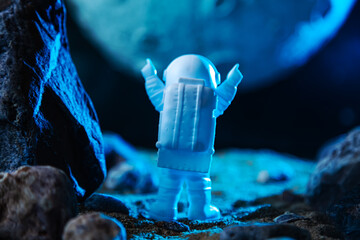Astronaut in a space suit raised his hands in a sign of welcome on another planet.