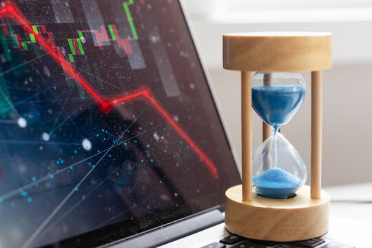 Hourglass on desk in front of computer monitor - Powered by Adobe