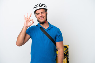 Young caucasian man with thermal backpack isolated on white background showing ok sign with fingers