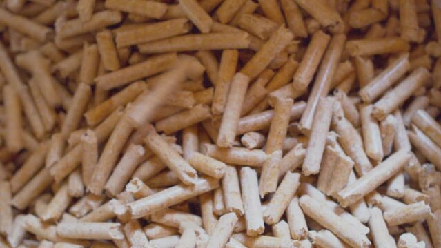 Wood processing.Alternative fuel.Wood pellets are poured into a container.Top view.Close-up.