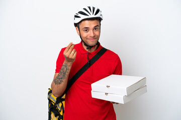 Young Brazilian man with thermal backpack isolated on white background making money gesture