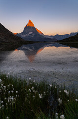 sunrise at Riffelsee early in the morning with a beautiful view of the Matterhorn with a burning top and the reflection in the lake in Zermatt, Switzerland