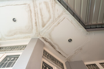 Ceiling panels with fungus outside house from water pipes damaged or rainy leaked. Office building...