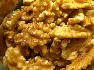 A small glass bottle of shelled walnuts.