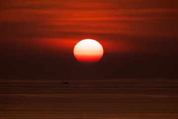 Closeup of bright big sun on the sky with yellow orange gradient colors during the sunset