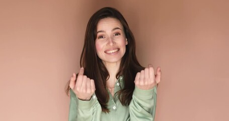 Attractive young woman look at camera see you, wave her hand, come to me. Hello, come to me! Portrait of friendly sociable woman in stylish green shirt gesturing hi, welcoming with raised hand.