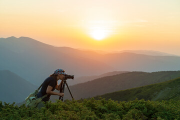 Girl photographer with tripod takes sunset photos - 639522202