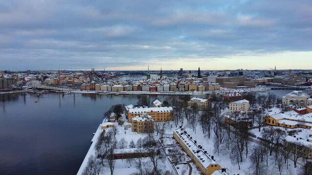 Beautiful winter aerial view of Stockholm city, Sweden. Old town, seascape, snow and colorful buildings. 4K resolution, 30 fps.