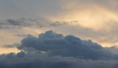 Sunset sky with majestic black clouds floating around.