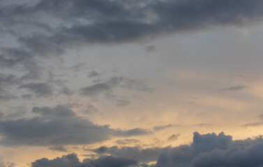 Sunset sky with majestic black clouds floating around.