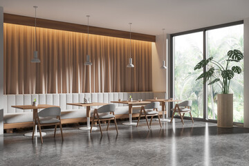 Fototapeta premium Stylish cafe interior with chairs and table, eating space with couch and window