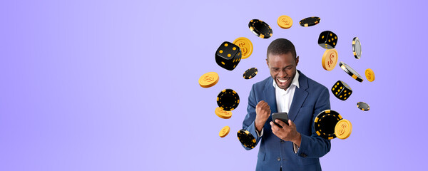 Black happy man with phone and arms raised, falling dice and coins, copy space