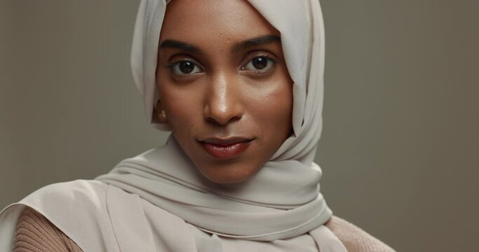 Face, muslim hijab or woman on studio background for beauty, fashion or arabic culture in Saudi Arabia. Serious portrait, young islamic model or scarf style of religion, elegant clothes or confidence
