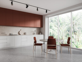 Stylish home kitchen interior with cooking and eating corner, panoramic window