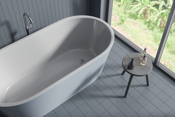 Top view of grey tile bathroom interior with bathtub and stool, panoramic window