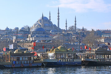 Street Food (Fish-Bread) Boats on the Golden Horn and Suleymaniye Mosque at the Background in Istanbul, Turkey.