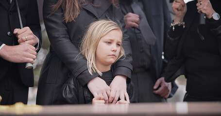 Child, sad and family at funeral at graveyard ceremony outdoor at burial place. Death, grief and group of people with casket or coffin at cemetery for service while mourning a loss at event or grave - obrazy, fototapety, plakaty