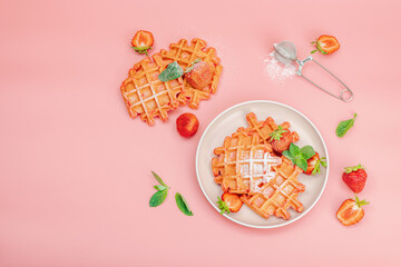 Homemade Belgian Waffles with strawberries. Gluten-free red dessert, fresh fruits and basil