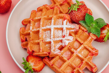 Homemade Belgian Waffles with strawberries. Gluten-free red dessert, fresh fruits and basil