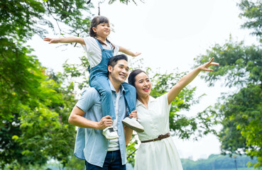 image of asian family walking in the park