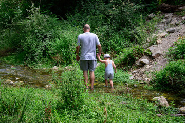 father and son walking by the river Nature. Healthy lifestyle. Family time